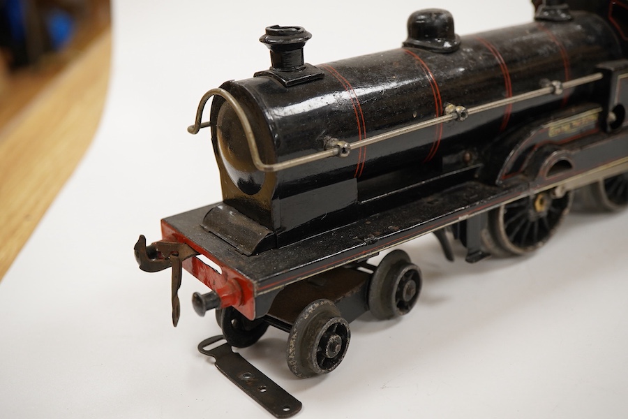 An 0 gauge Bing for Bassett-Lowke tinplate clockwork LNWR 4-4-0 tender locomotive, George the Fifth 2663, in red lined black livery with original clockwork mechanism